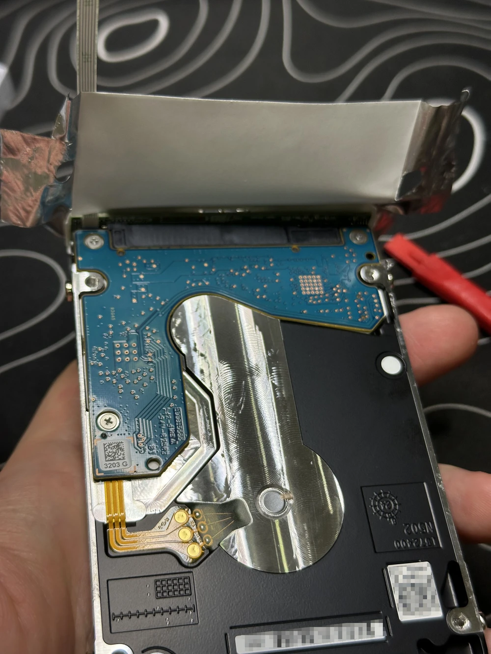 “Foil” peeled off, revealing the SATA↔USB Micro-B adapter